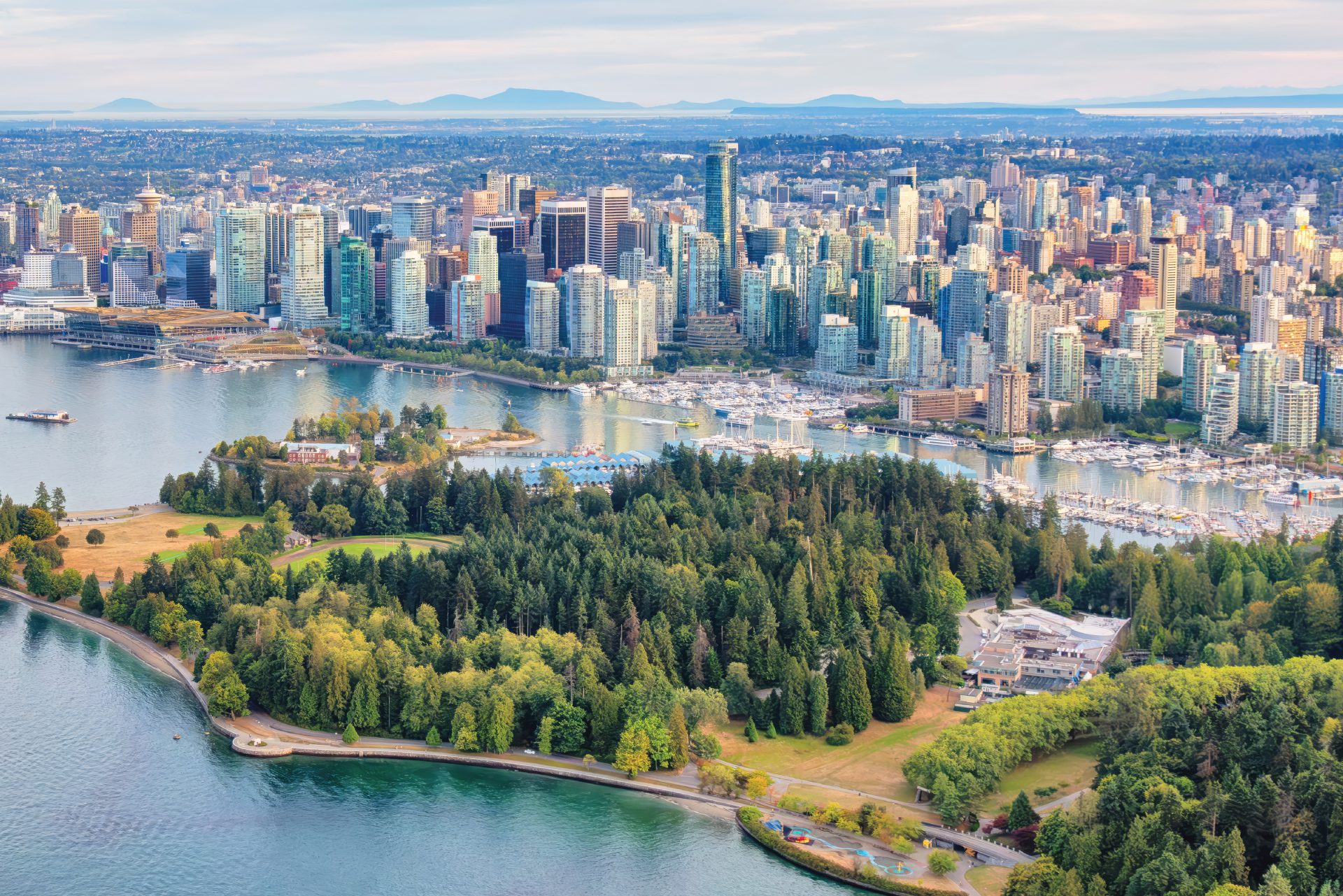 Aerial view of downtown Vancouver, its waterfront and surrounding mountains.